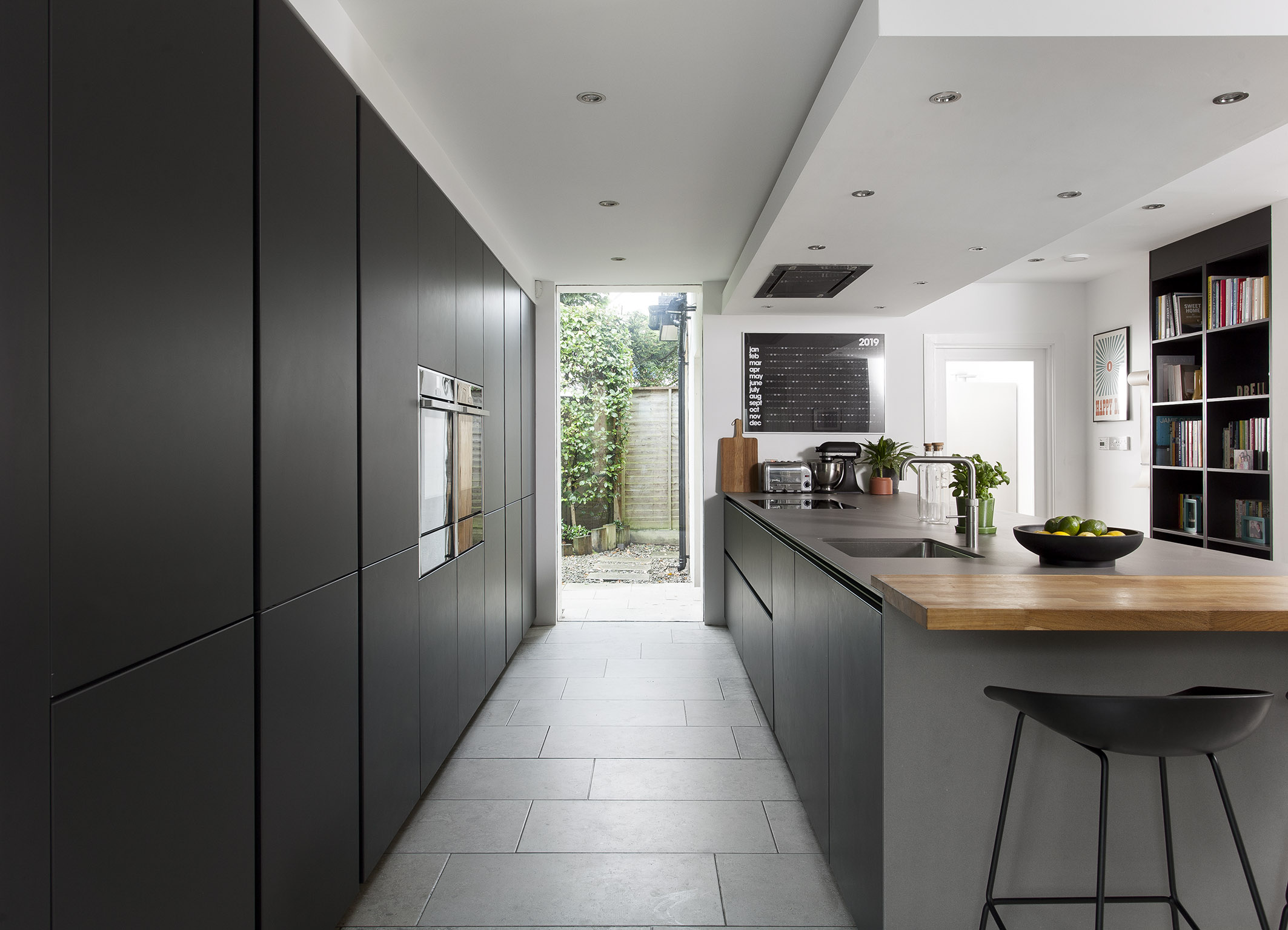 White hi gloss kitchen with coffee station and hidden utility
