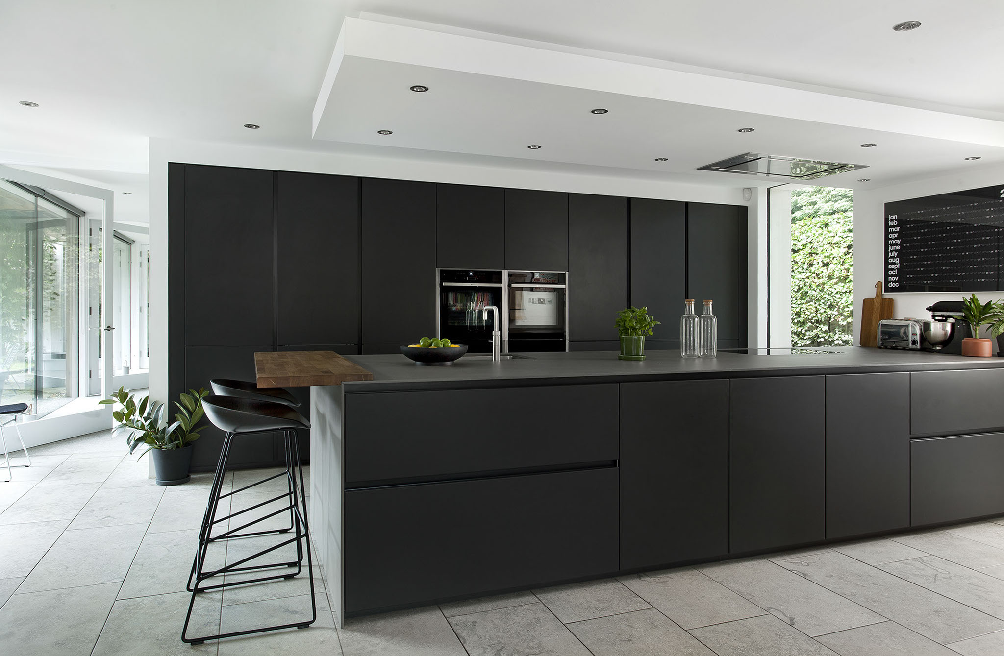 White hi gloss kitchen with coffee station and hidden utility