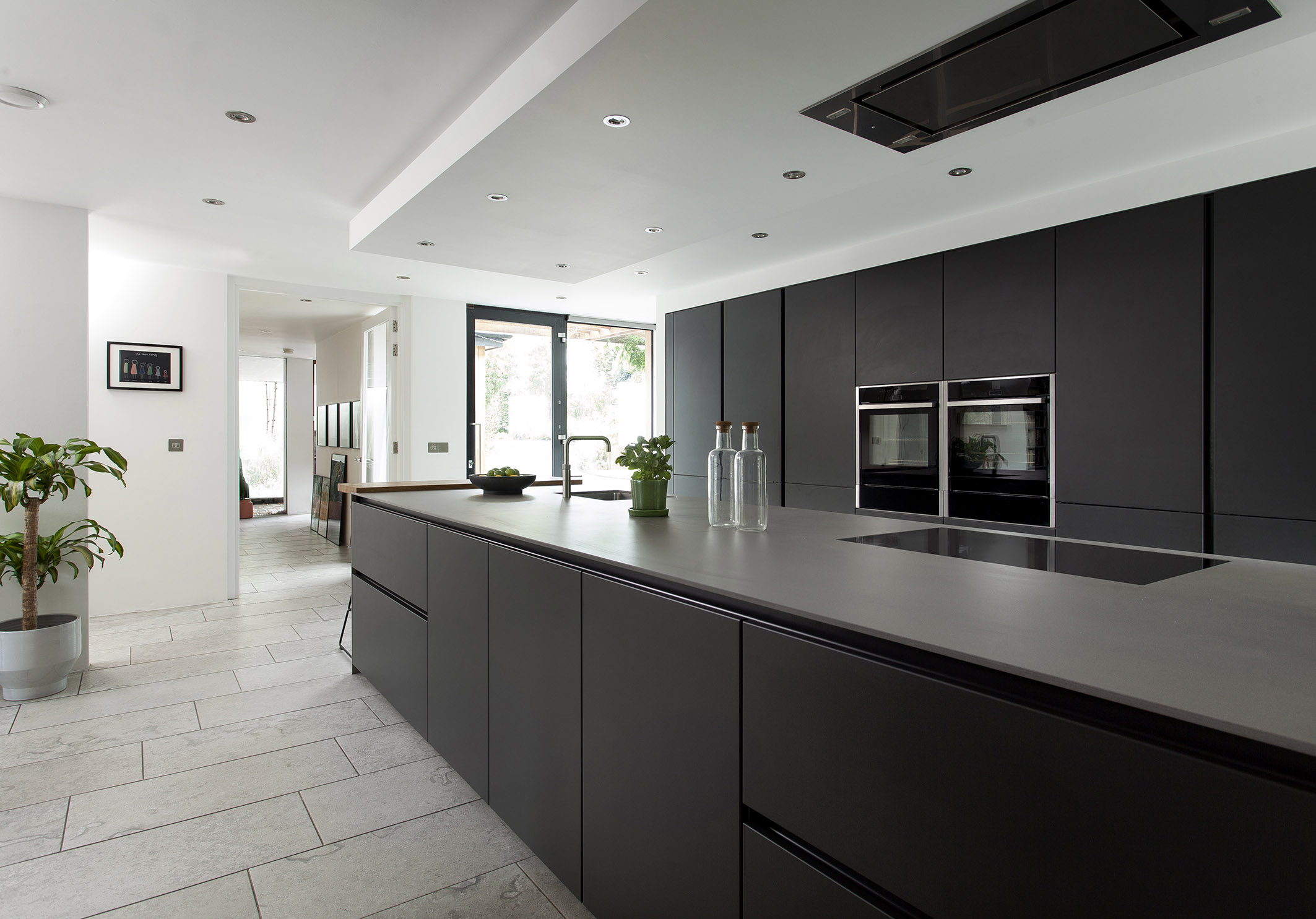 White hi gloss kitchen with coffee station and hidden utility