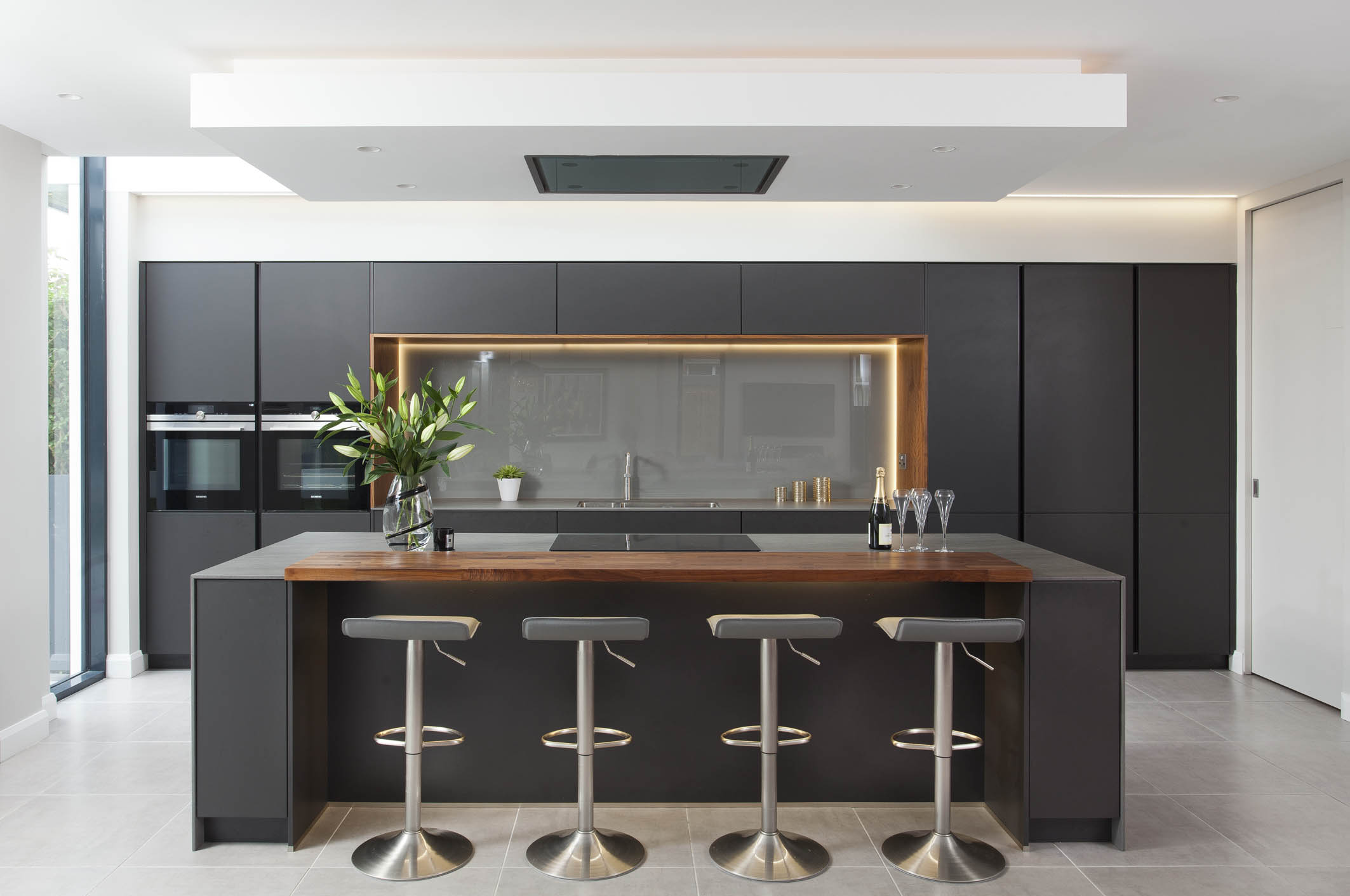 White hi gloss kitchen with coffee station and hidden utility