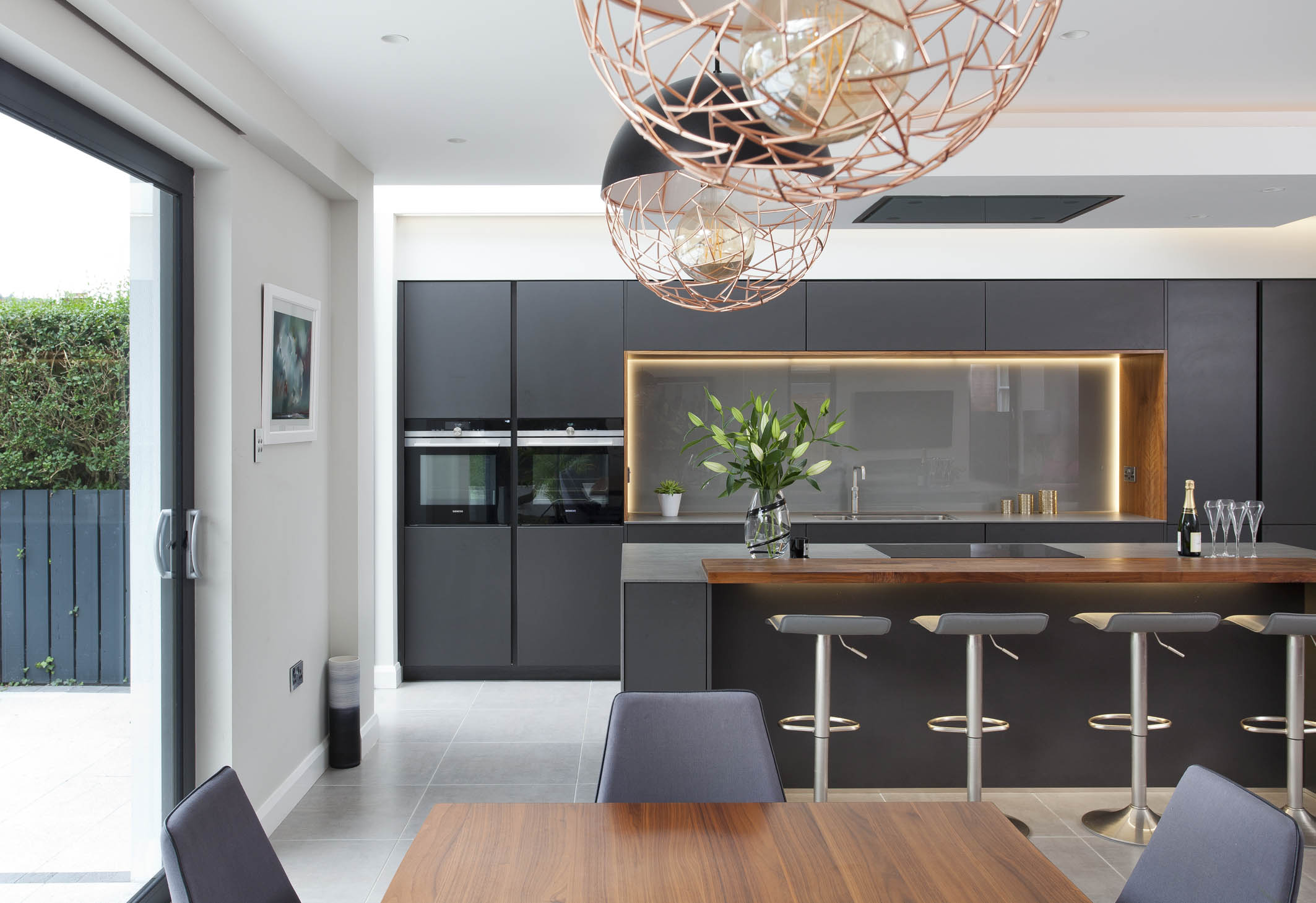 White hi gloss kitchen with coffee station and hidden utility