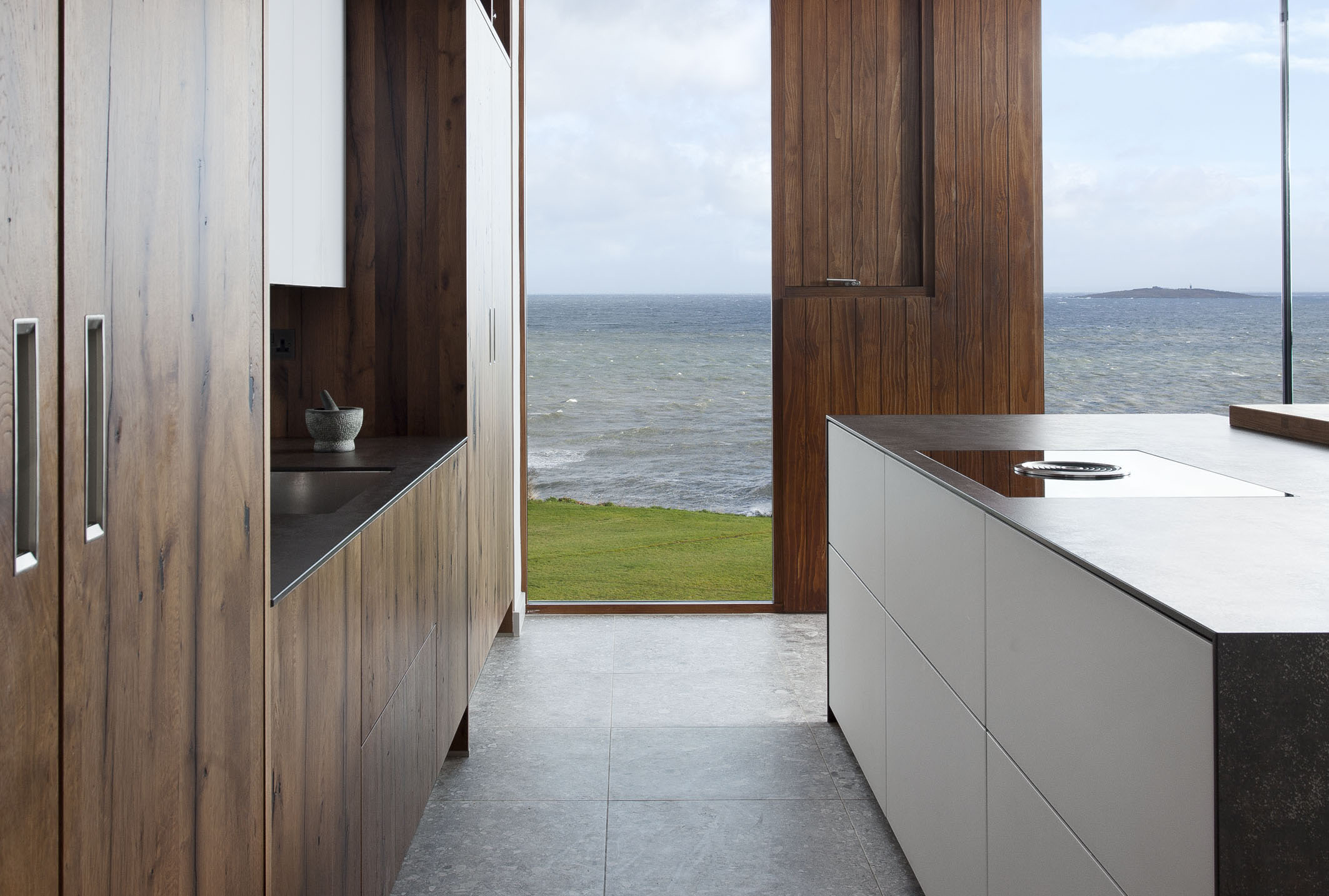 White hi gloss kitchen with coffee station and hidden utility