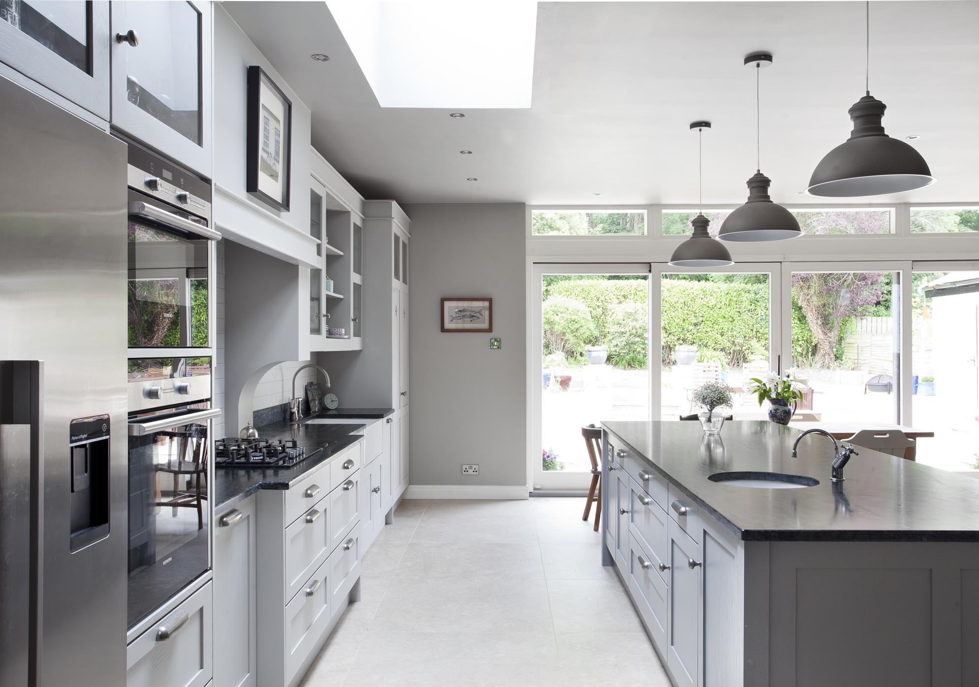 White hi gloss kitchen with coffee station and hidden utility