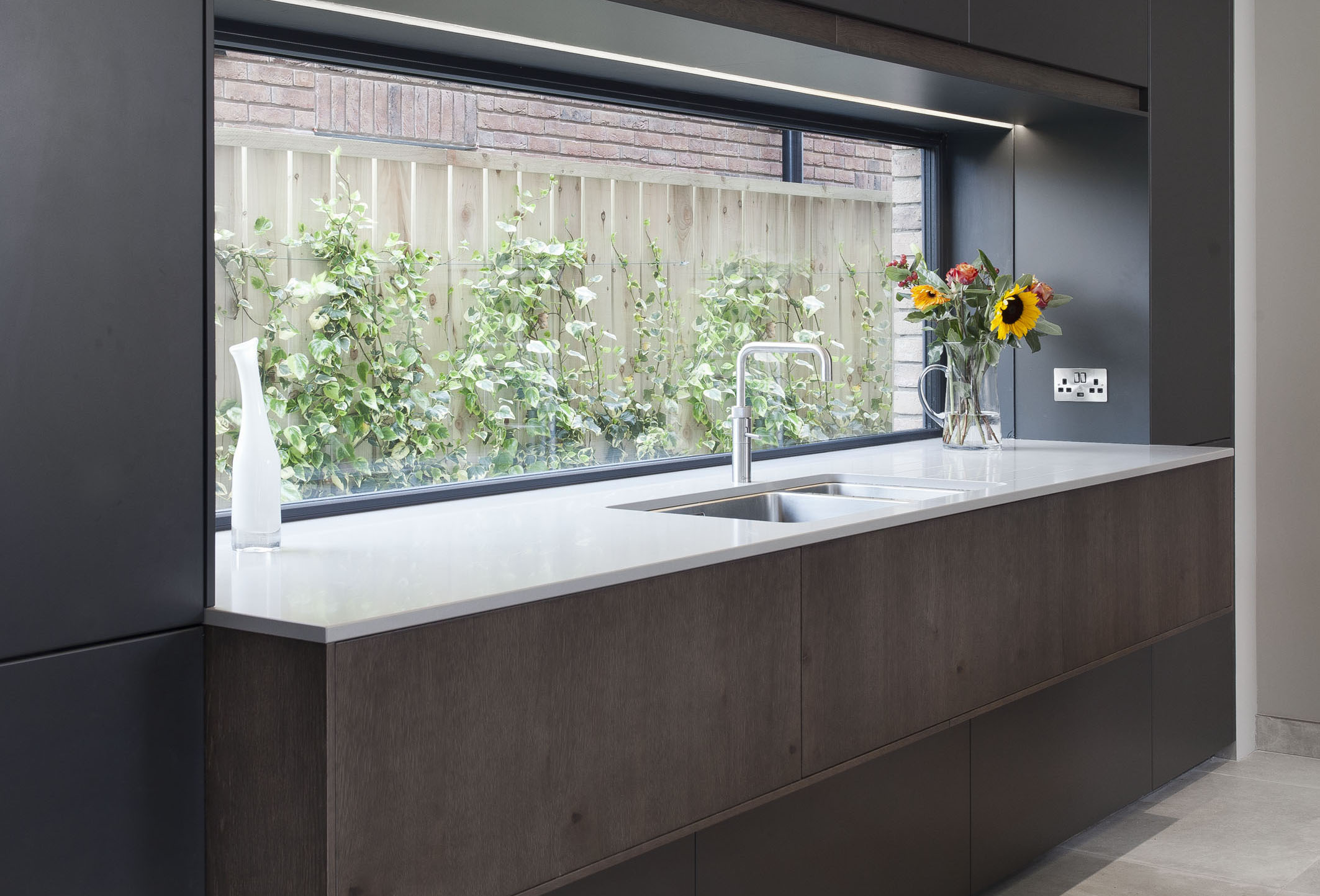 White hi gloss kitchen with coffee station and hidden utility