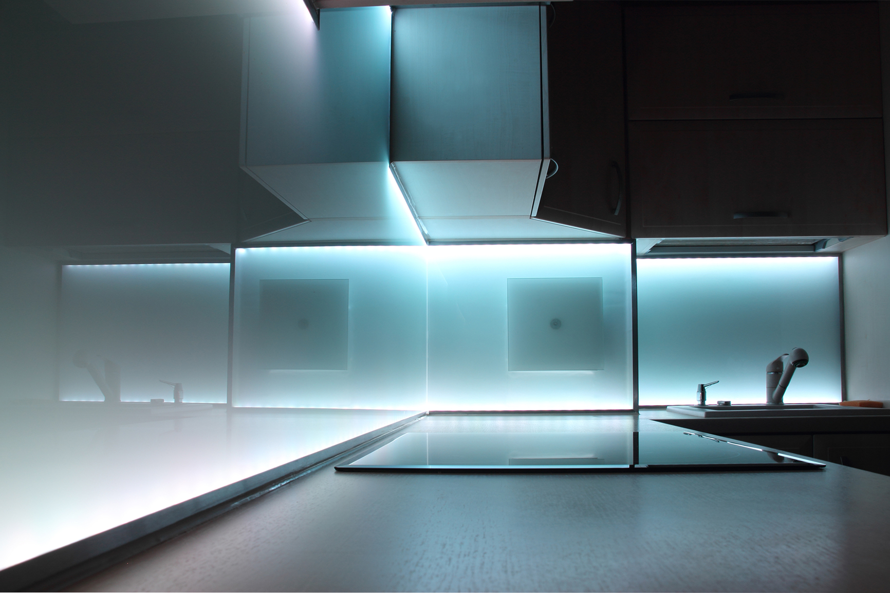 A contemporary kitchen, lit with abespoked LED lighting 