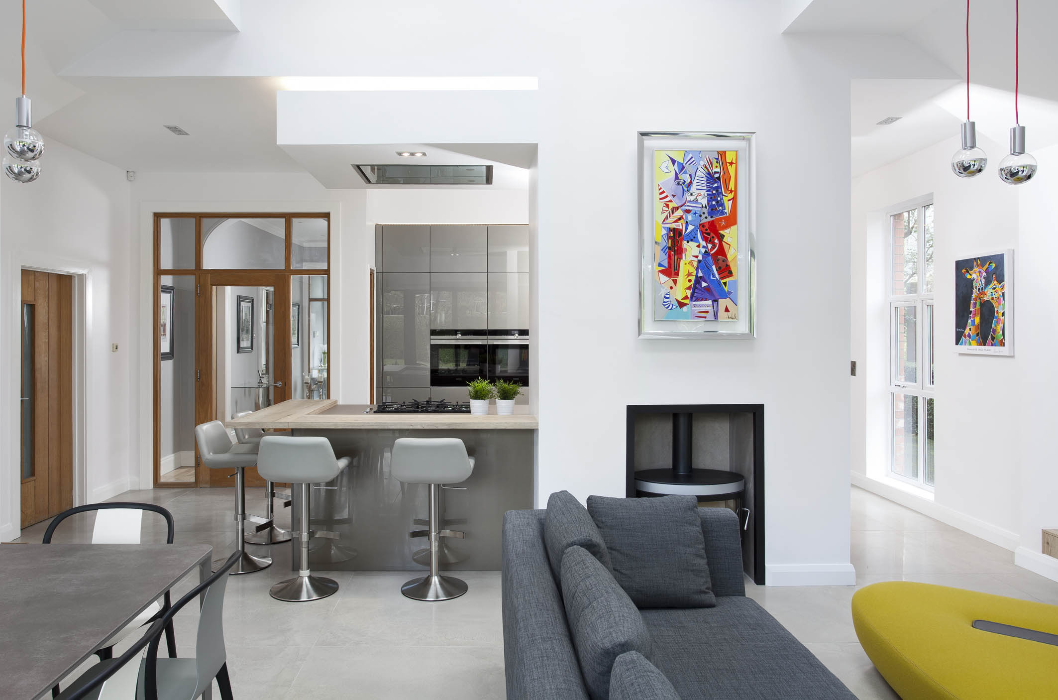 White hi gloss kitchen with coffee station and hidden utility