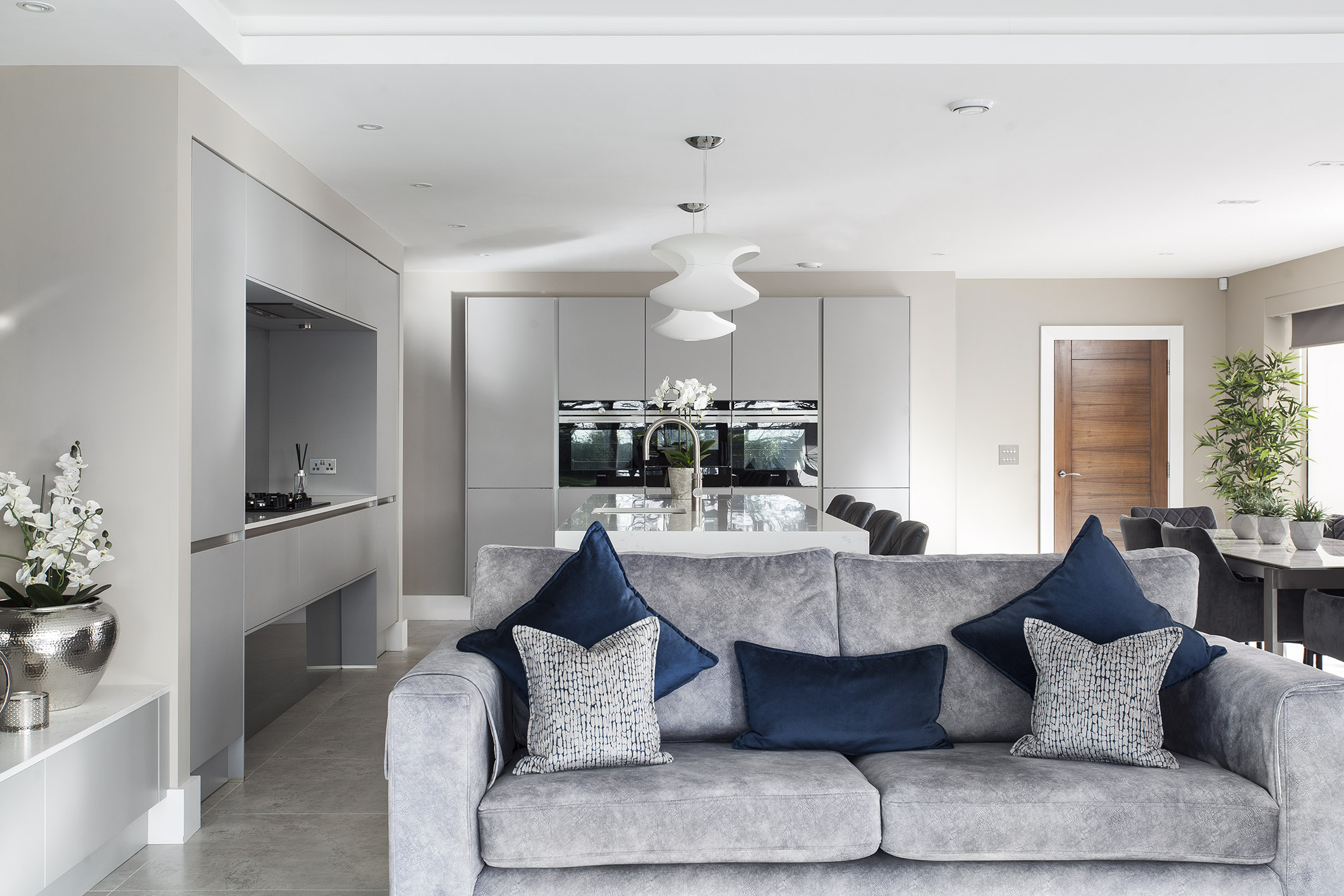 White hi gloss kitchen with coffee station and hidden utility