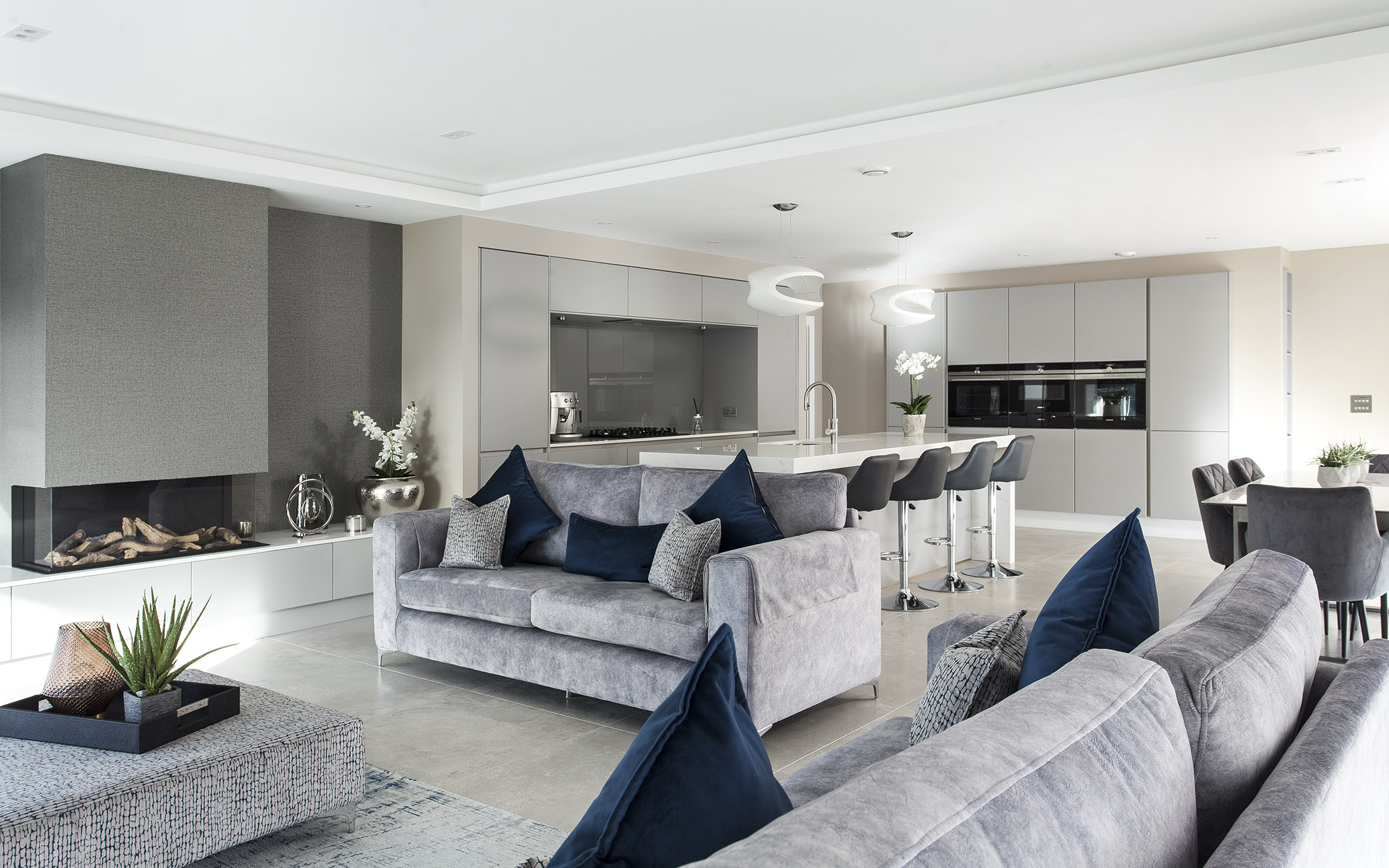 White hi gloss kitchen with coffee station and hidden utility