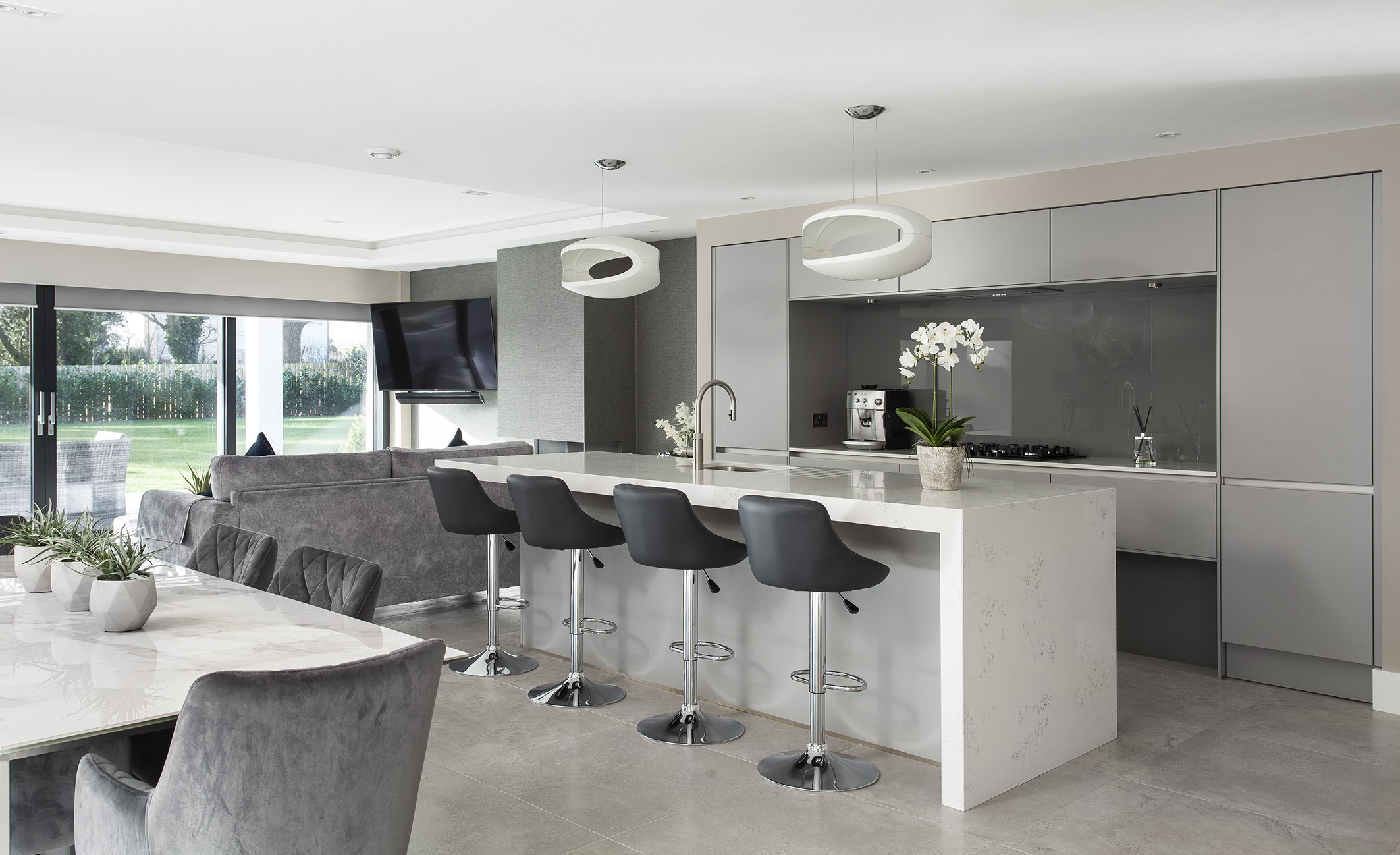 White hi gloss kitchen with coffee station and hidden utility