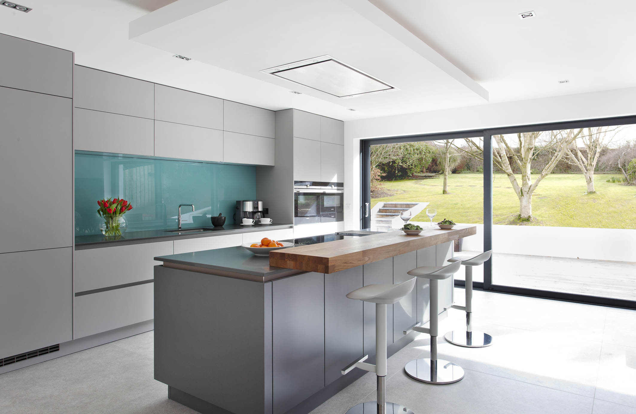 White hi gloss kitchen with coffee station and hidden utility