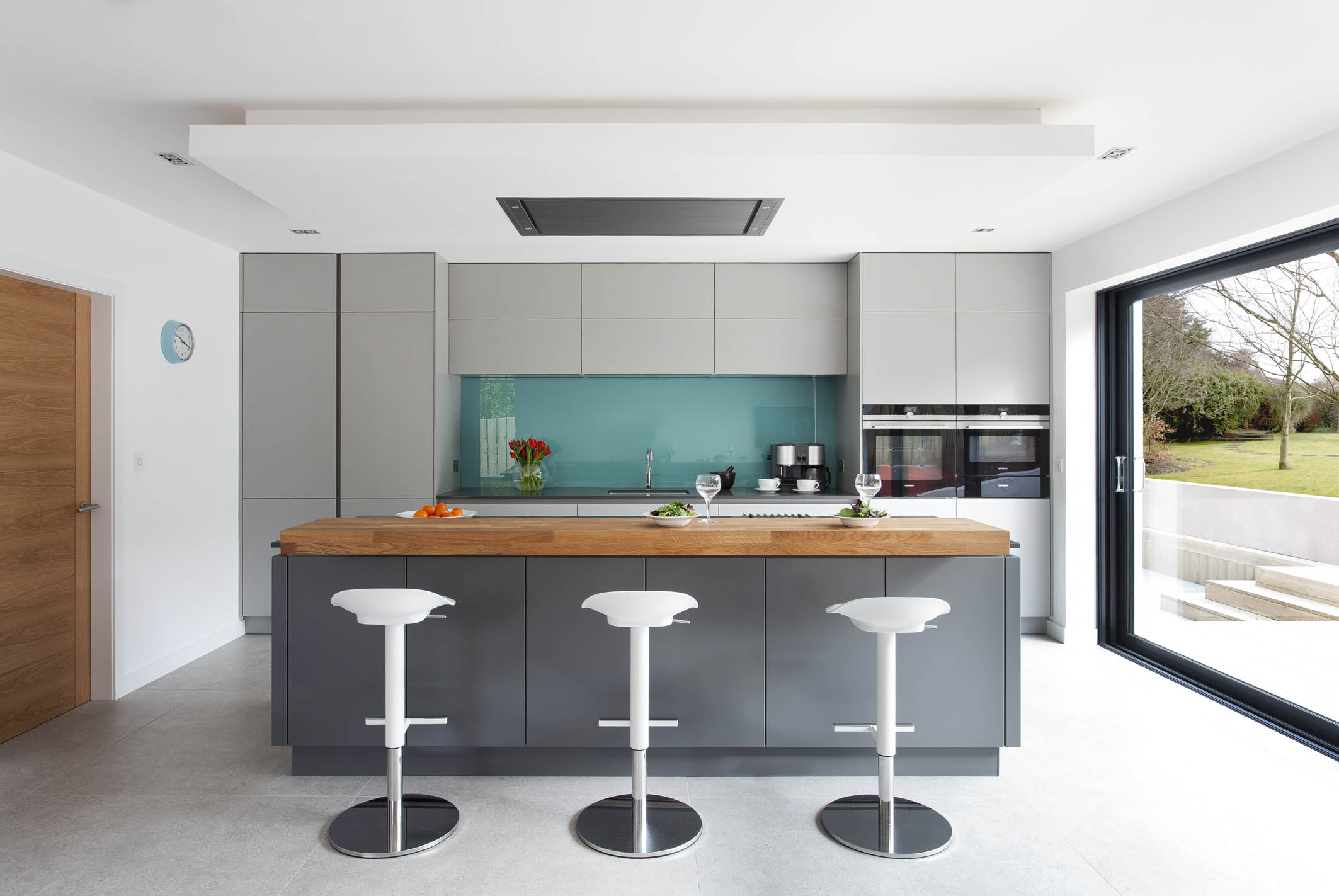 White hi gloss kitchen with coffee station and hidden utility