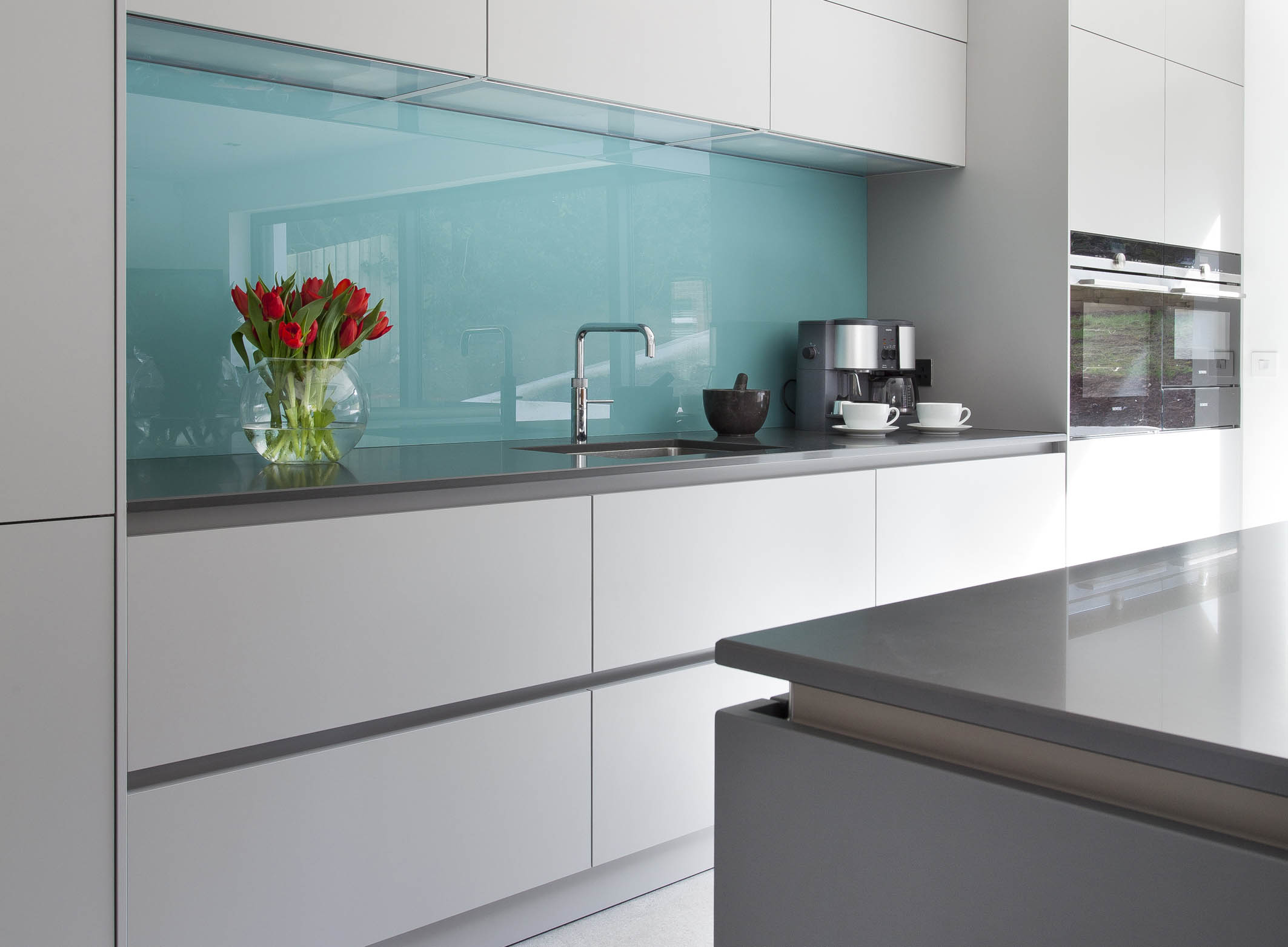 White hi gloss kitchen with coffee station and hidden utility