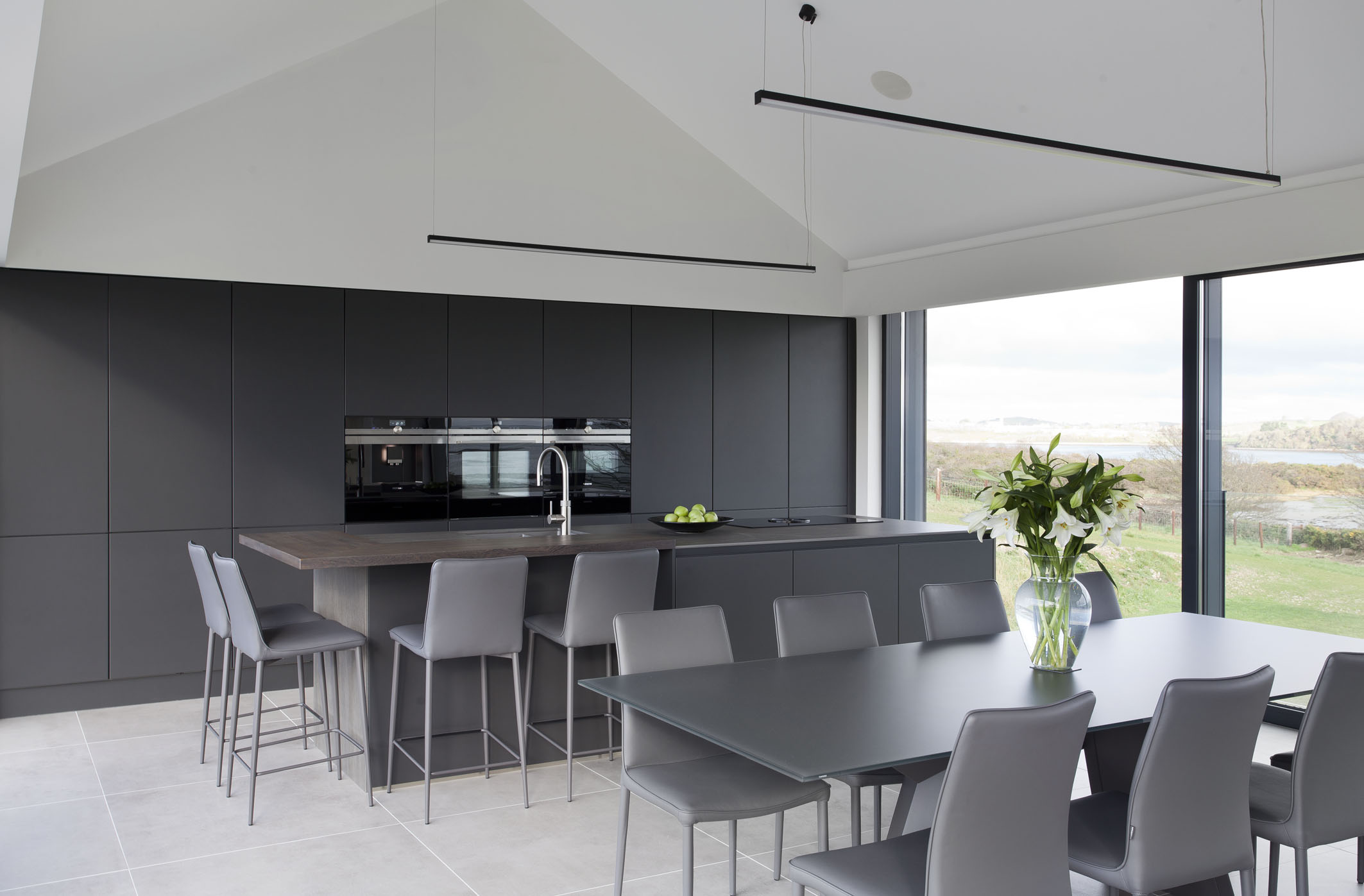 White hi gloss kitchen with coffee station and hidden utility