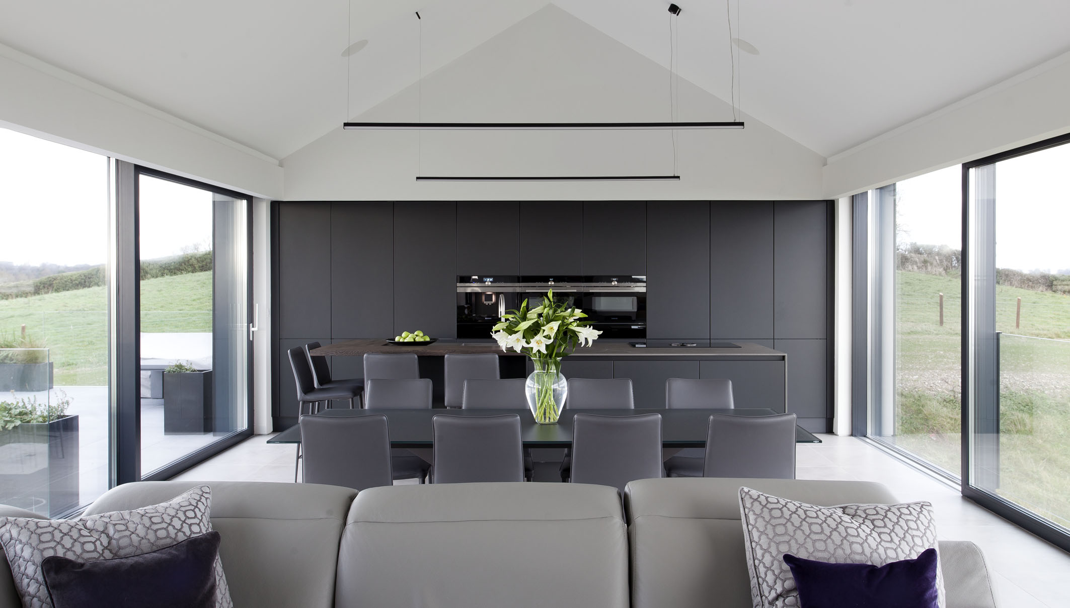 White hi gloss kitchen with coffee station and hidden utility