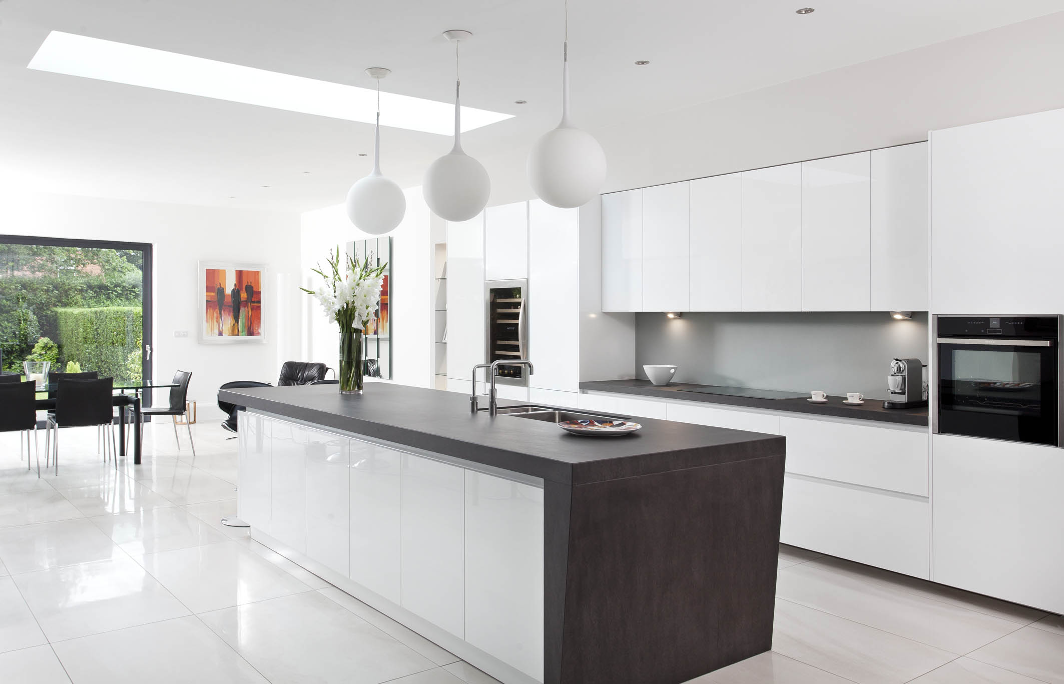 White hi gloss kitchen with coffee station and hidden utility