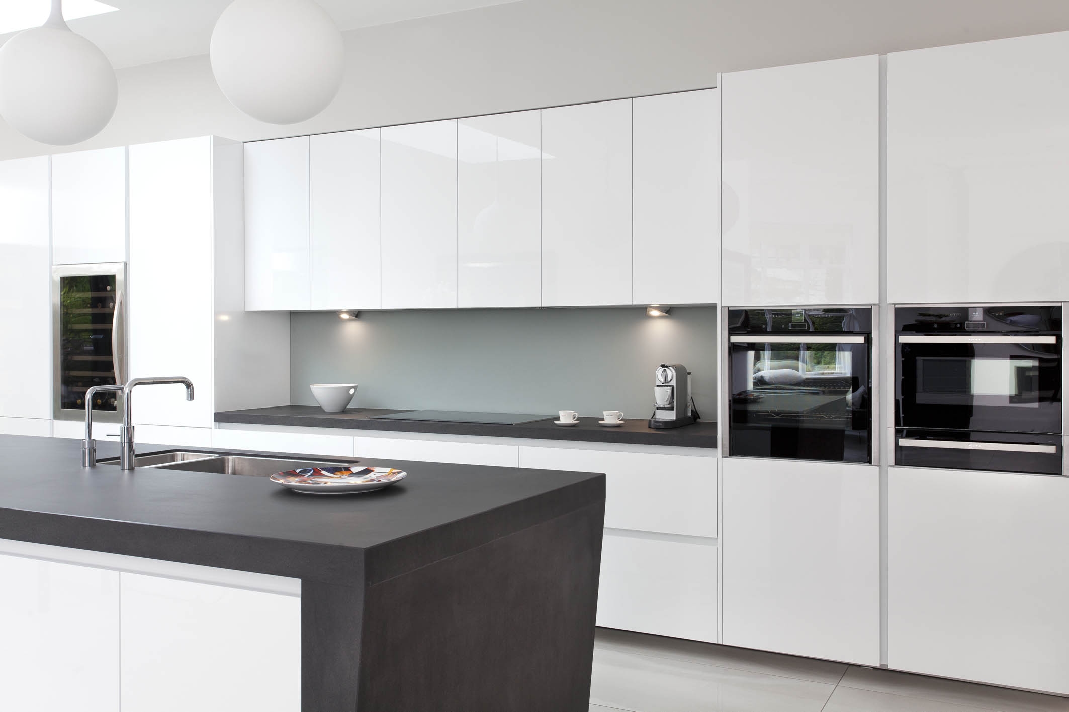 White hi gloss kitchen with coffee station and hidden utility