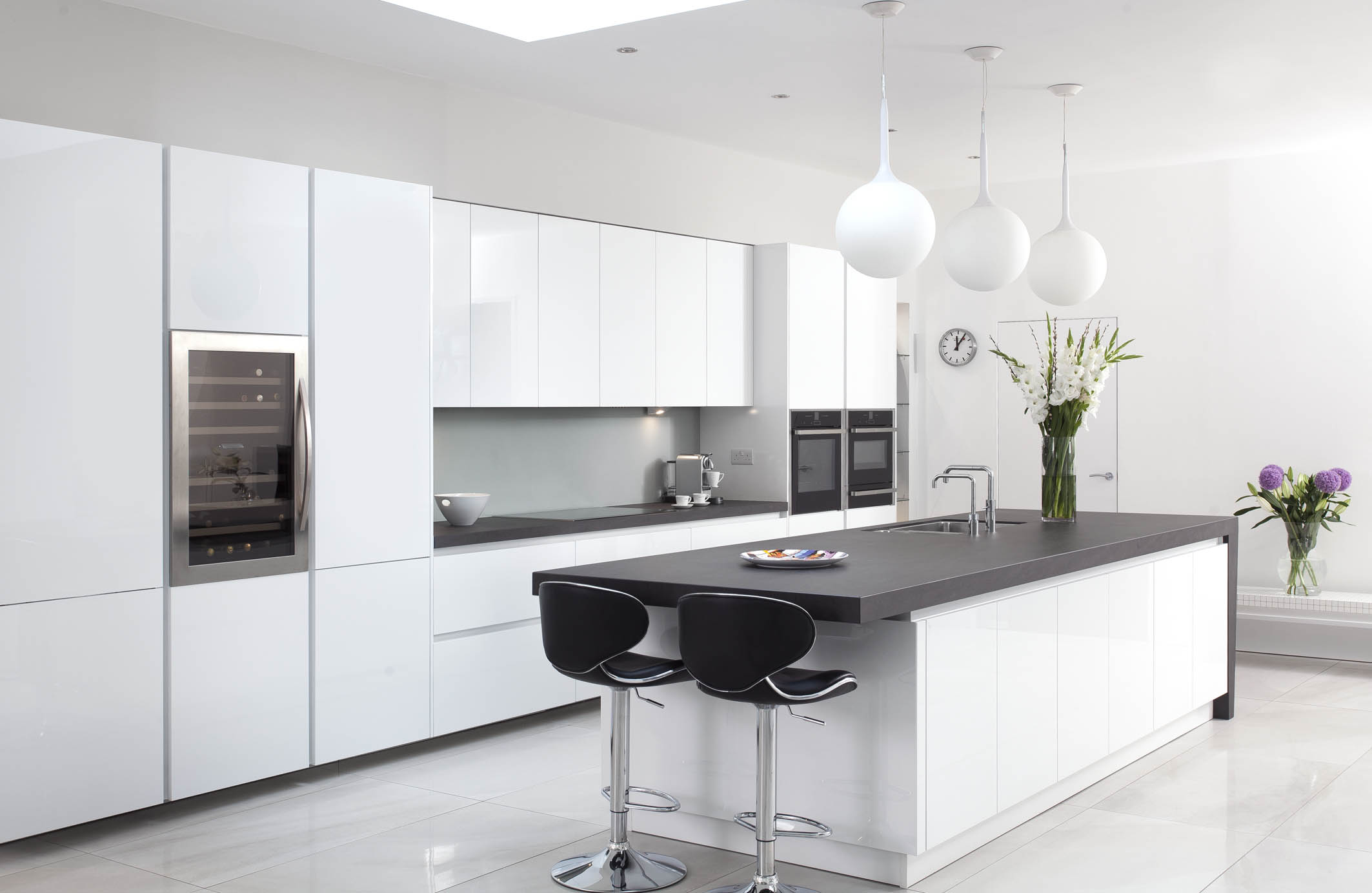 White hi gloss kitchen with coffee station and hidden utility