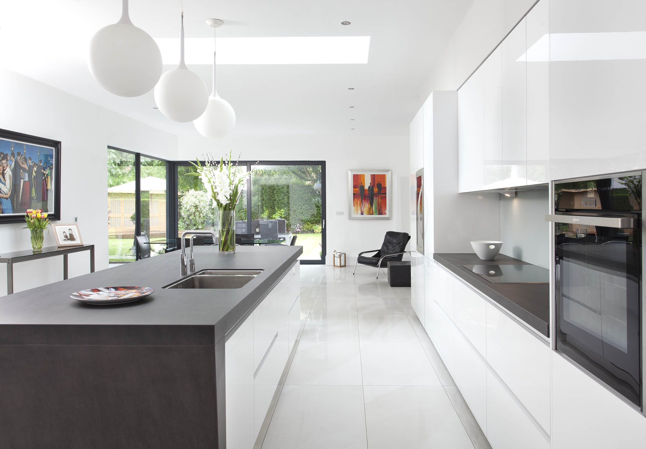 White hi gloss kitchen with coffee station and hidden utility