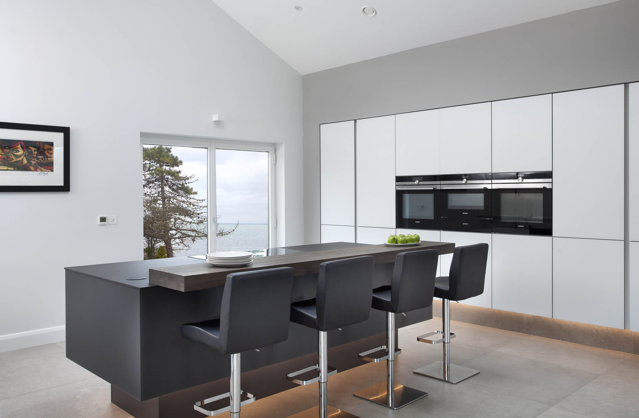 White hi gloss kitchen with coffee station and hidden utility