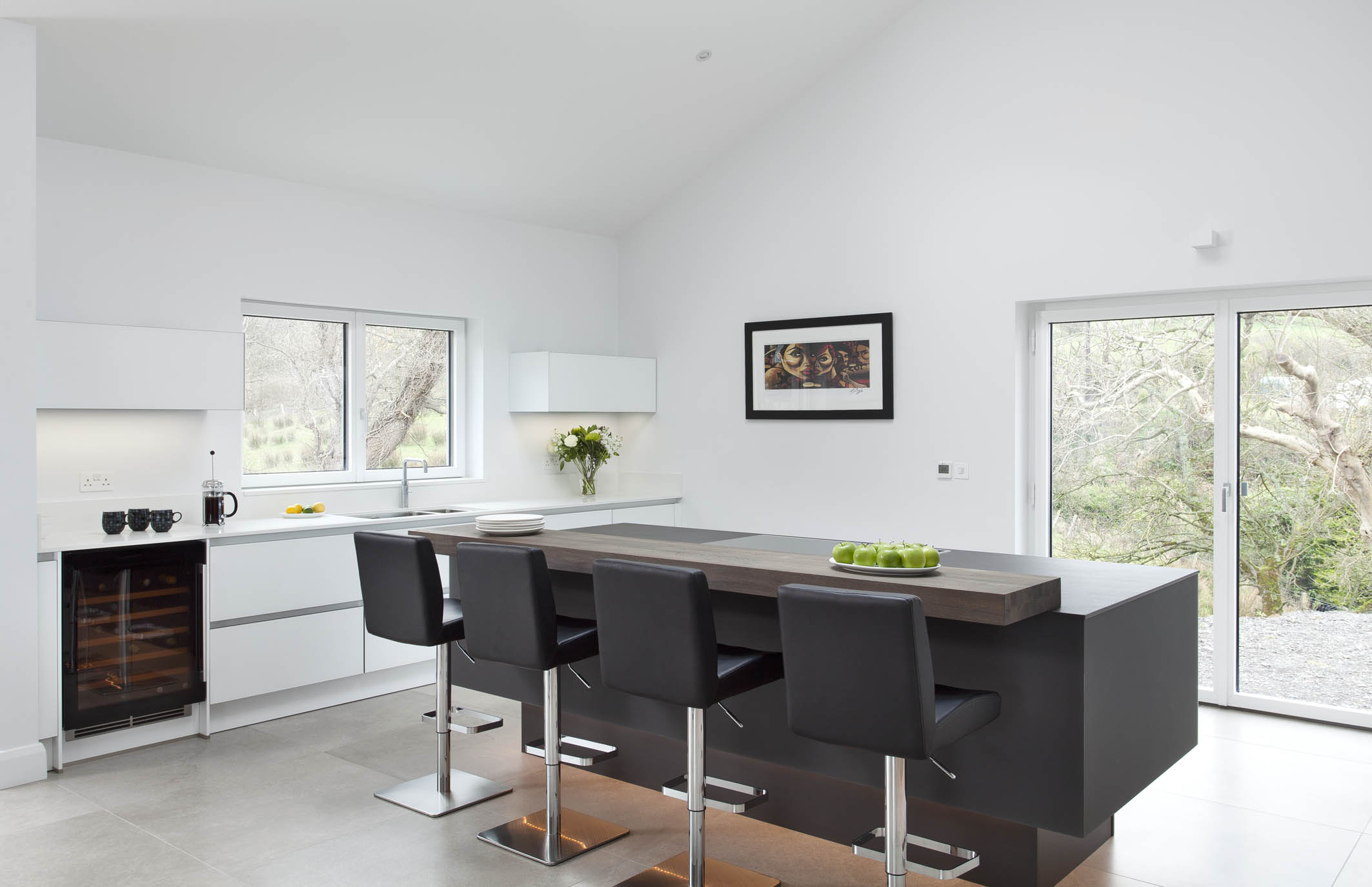 White hi gloss kitchen with coffee station and hidden utility