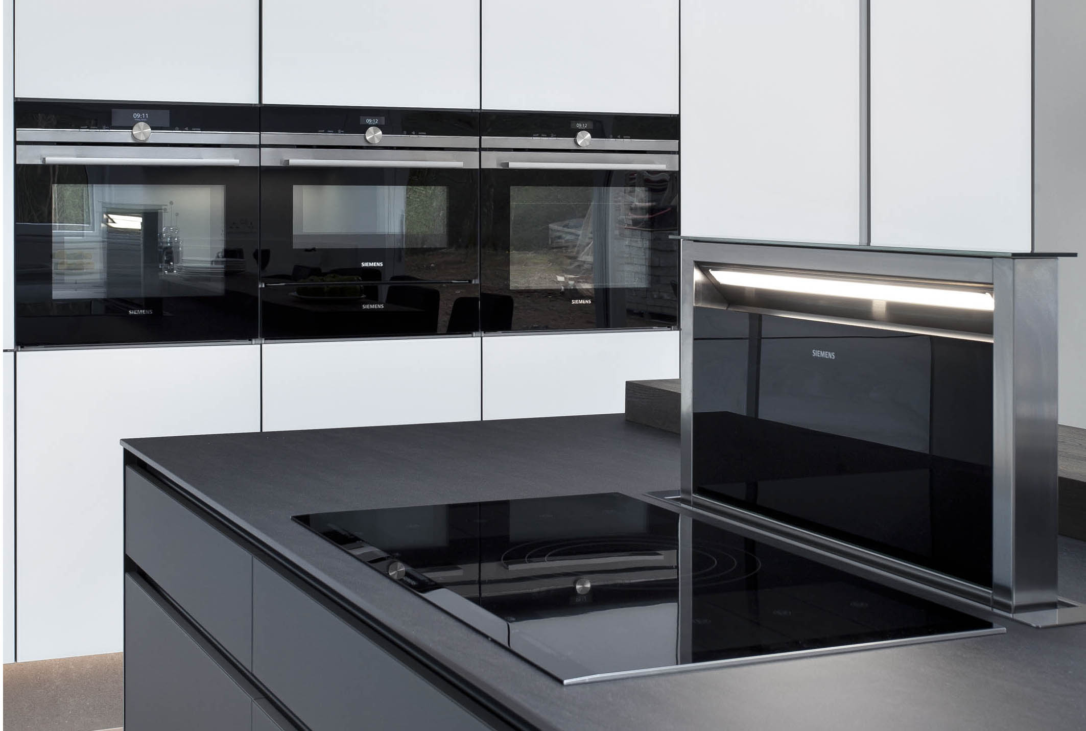 White hi gloss kitchen with coffee station and hidden utility